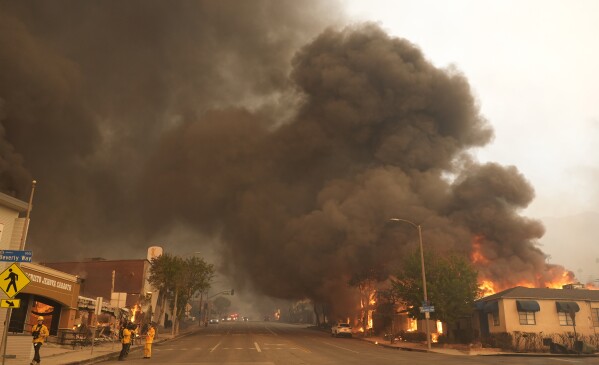 Black smoke rises over Lake Avenue during the Eaton Fire, Jan. 8, 2025, in Altadena, Calif. (AP Photo/Chris Pizzello, File)